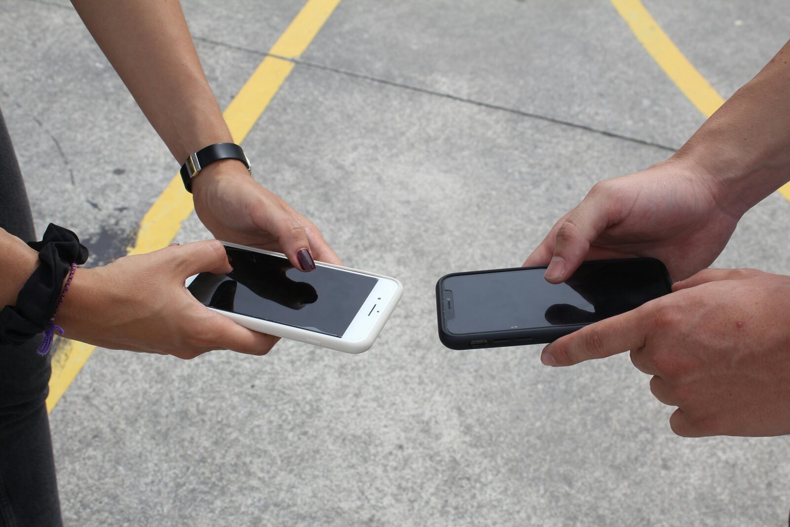 Hands exchanging phones
